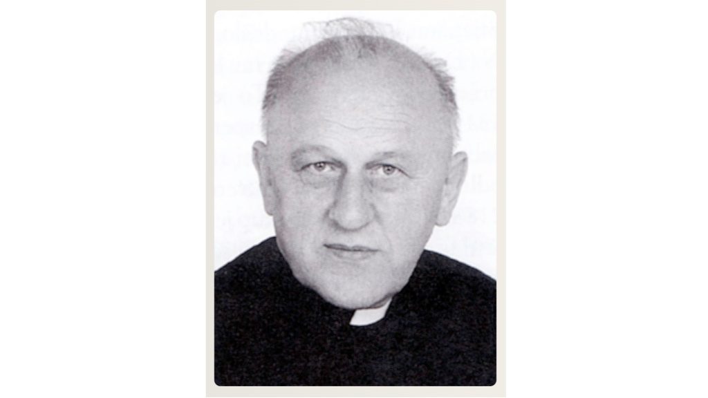 Black-and-white portrait of a middle-aged man in a clerical collar looking at the camera.